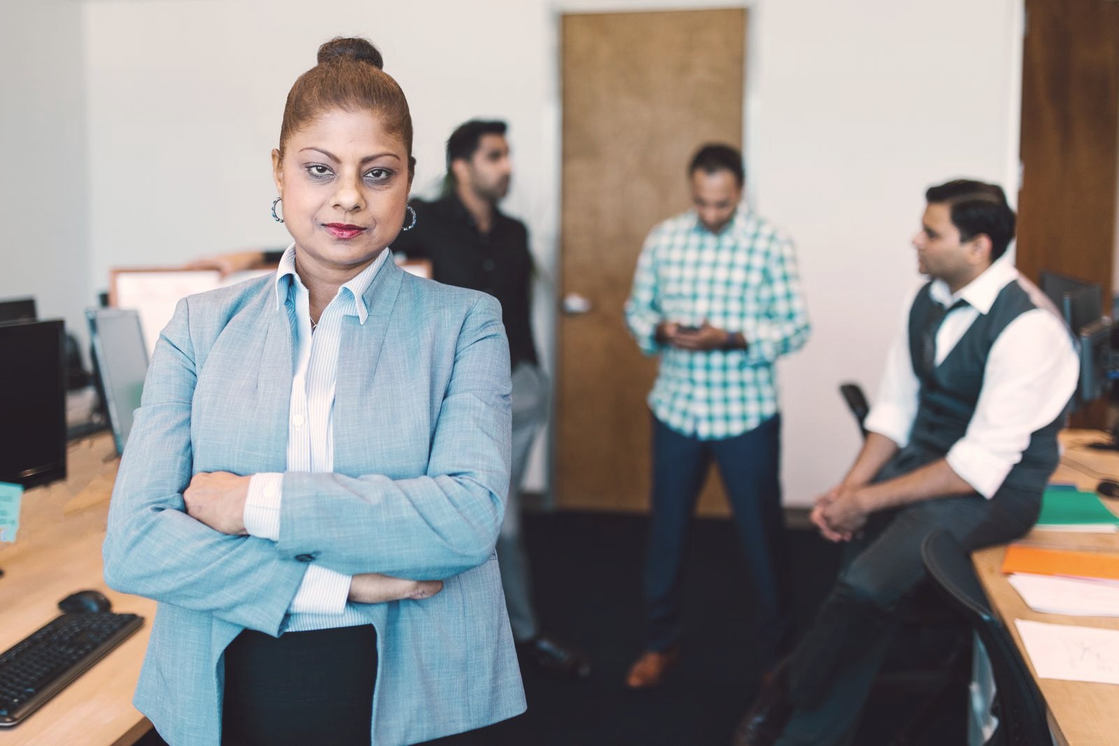 A business leader with her team in an office